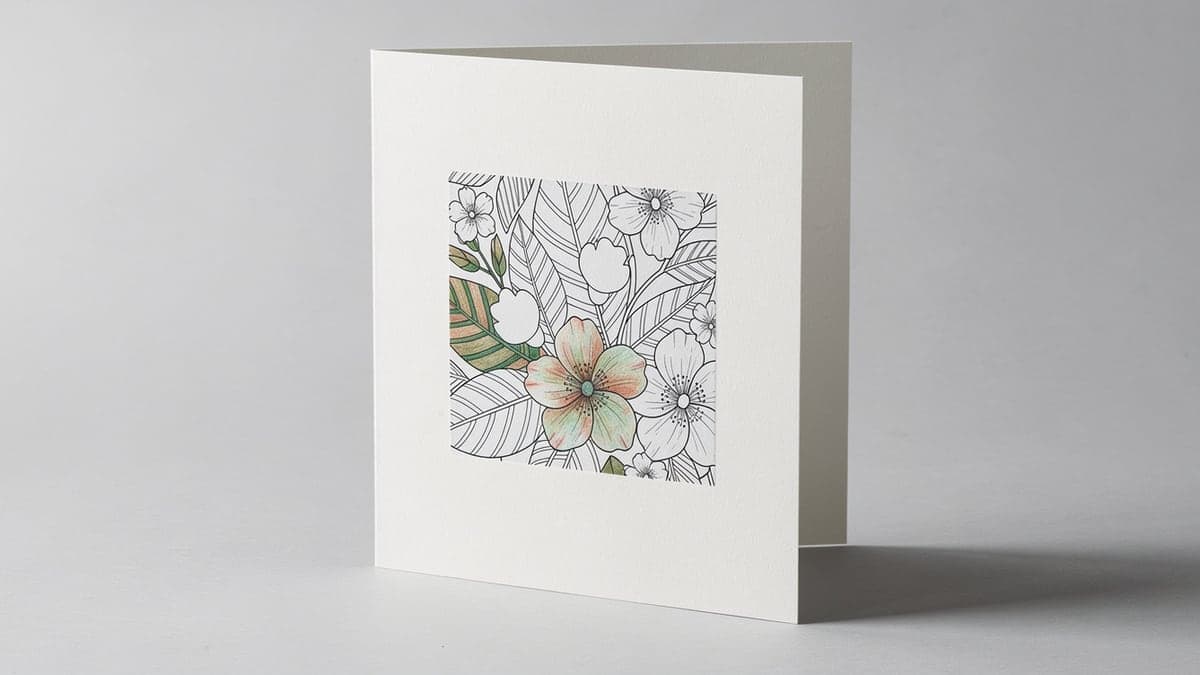 Upright folded card with a partially hand-colored botanical panel mounted squarely inside an even blank border